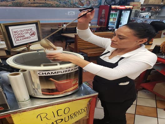 Serving champurrado at Tacos 5 de Mayo in El Mercadito